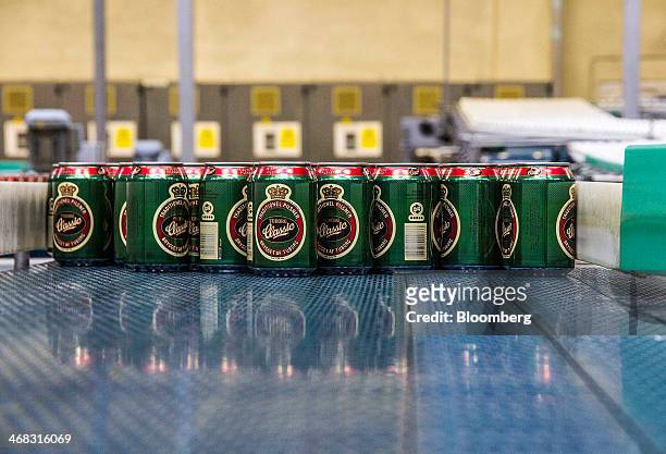 Cans of Tuborg Classic beer move along the production line at the Carlsberg A/S brewery in Fredericia, Denmark, on Sunday, Feb. 9, 2014. The...