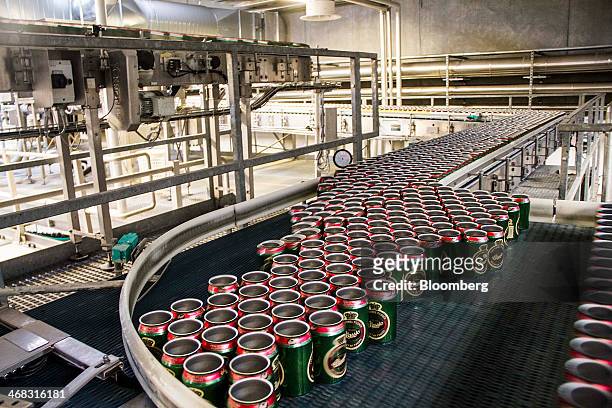 Lidless and empty Tuborg Classic beer cans move along the production line at the Carlsberg A/S brewery in Fredericia, Denmark, on Sunday, Feb. 9,...