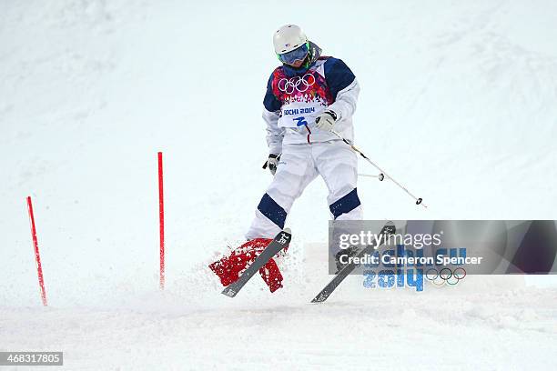 Patrick Deneen of the United States has a flag caught on his ski in the Men's Moguls Qualification on day three of the Sochi 2014 Winter Olympics at...