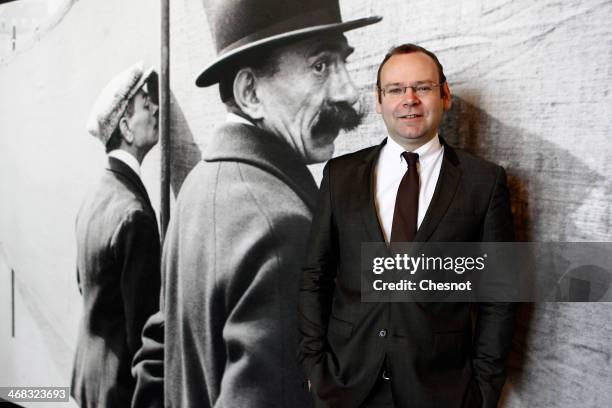 Commissioner of the exhibition, Clement Cheroux poses in front of a picture by french photographer Henri Cartier-Bresson during the inauguration of...