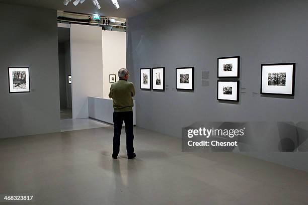 Visitor looks at pictures by french photographer Henri Cartier-Bresson during the inauguration of his exhibition at Centre Pompidou on February 10,...