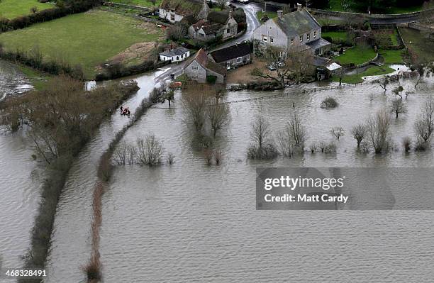 Flood water covers the road to the village of Muchelney on the Somerset Levels near Langport on February 10, 2014 in Somerset, England. Thousands of...