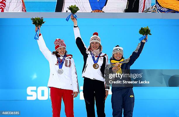 Silver medalist Olga Vilukhina of Russia, gold medalist Anastasiya Kuzmina of Slovakia and bronze medalist Vita Semerenko of Ukraine celebrate during...