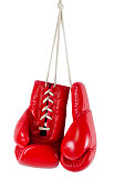 Hanging red boxing gloves on white background