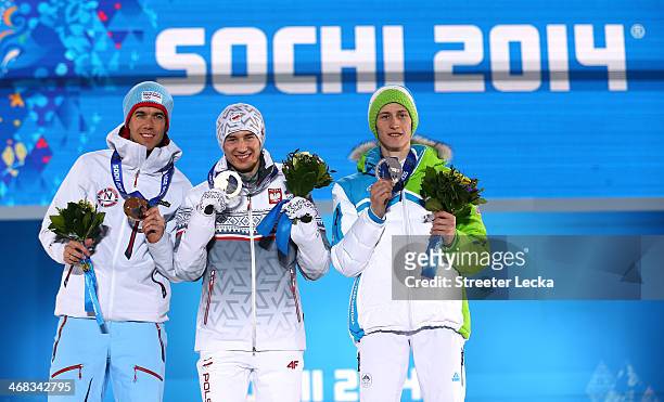 Bronze medalist Anders Bardal of Norway, gold medalist Kamil Stoch of Poland and silver medalist Peter Prevc of Slovenia celebrate during the medal...