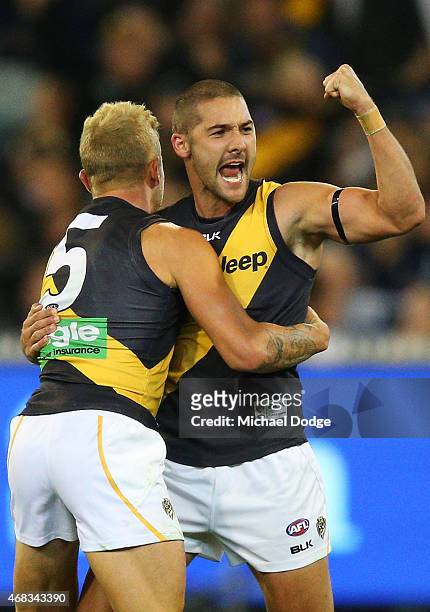 Brandon Ellis and Shaun Grigg of the Tigers celebrate a goal during the round one AFL match between the Carlton Blues and the Richmond Tigers at...