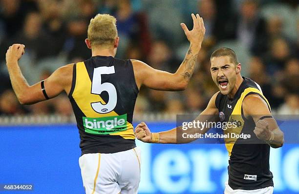 Brandon Ellis and Shaun Grigg of the Tigers celebrate a goal during the round one AFL match between the Carlton Blues and the Richmond Tigers at...