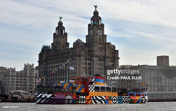 The newly decorated Mersey Ferry 'Snowdrop', painted to a design by artist Sir Peter Blake, is seen in the River Mersey in front of the Liver...