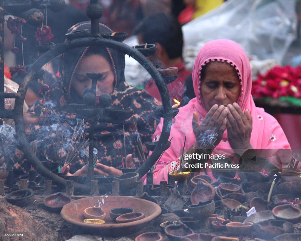 Pakistani devotees  performing religious rituals and praying...