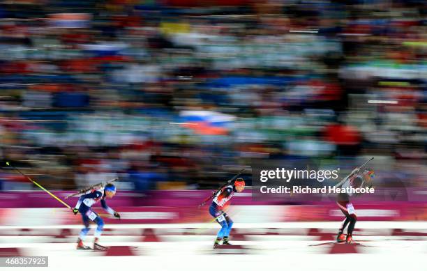 Tim Burke of United States, Evgeny Ustyugov of Russia and Christoph Sumann of Austria compete in the Men's 12.5 km Pursuit during day three of the...