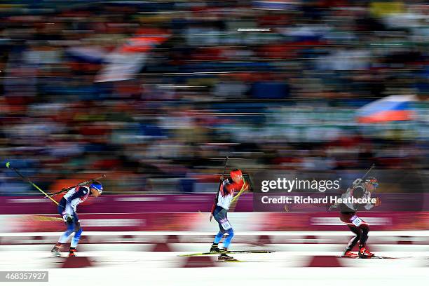 Tim Burke of United States, Evgeny Ustyugov of Russia and Christoph Sumann of Austria compete in the Men's 12.5 km Pursuit during day three of the...