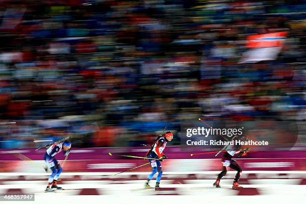 Tim Burke of United States, Evgeny Ustyugov of Russia and Christoph Sumann of Austria compete in the Men's 12.5 km Pursuit during day three of the...