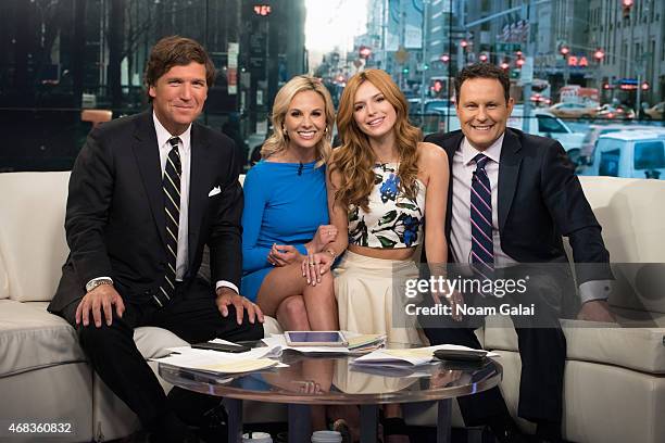 Tucker Carlson, Elisabeth Hasselbeck, actress Bella Thorne and Brian Kilmeade pose onstage during 'Fox & Friends' at FOX Studios on April 2, 2015 in...