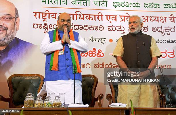 Indian Bharatiya Janata Party national president Amit Shah gestures as Prime Minister Narendra Modi looks on during a BJP office bearers' meeting...