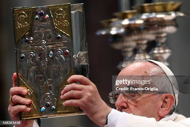Pope Francis holds the gospel as he attends the Chrism Mass at St. Peter's Basilica on April 2, 2015 in Vatican City, Vatican. The Chrism Mass is the...