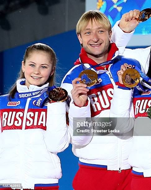 Gold medalists Yulia Lipnitskaya and Evgeny Plyushchenko of Russia celebrate during the medal ceremony for the Team Figure Skating Overall on day 3...