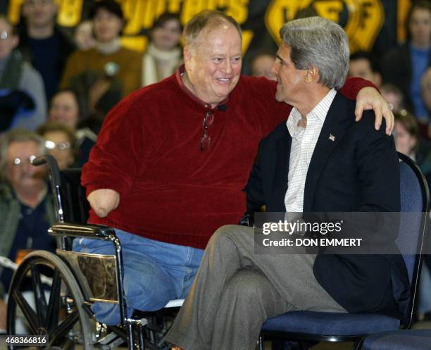 Former US senator from Georgia and Vietnam veteran Max Cleland embraces Democratic presidential hopeful US Senator John Kerry of Massachusetts during...