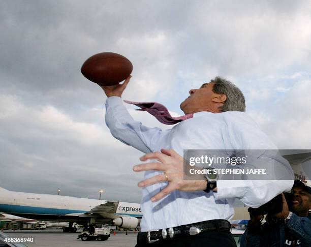 Democratic presidential candidate Senator John Kerry plays football on the tarmac of Hartsfield Airport 02 March 2004 in Atlanta, Georgia. Kerry has...
