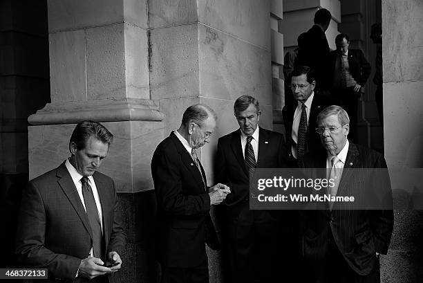 Republican senators wait for a bus outside the U.S. Capitol for a ride to the White House for a meeting with U.S. President Barack Obama on ending...