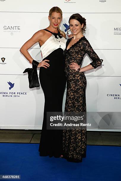 Giulia Siegel and Anna Weiss arrive for the Cinema For Peace 2014 - Gala at Konzerthaus Am Gendarmenmarkt on February 10, 2014 in Berlin, Germany.