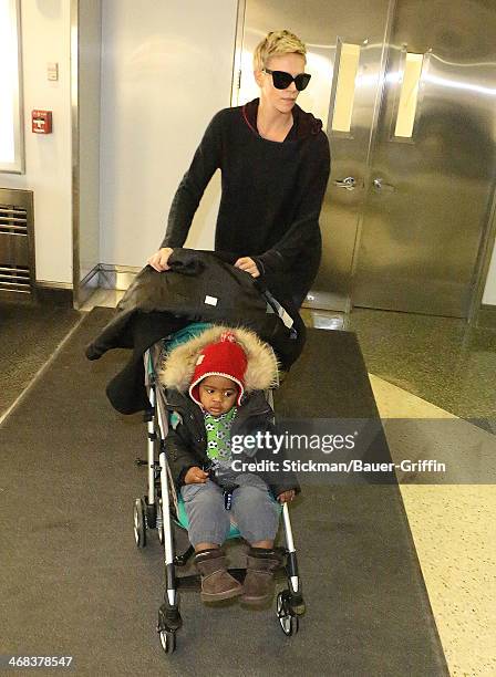 Charlize Theron and her son Jackson Theron are seen arriving at Logan International Airport on March 16, 2013 in Boston, Massachusetts.