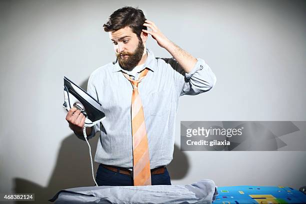 ironing is not a man's job. - iron stock pictures, royalty-free photos & images