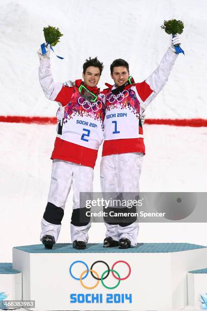 Silver medalist Mikael Kingsbury of Canada and gold medalist Alex Bilodeau of Canada celebrate on the podium during the flower ceremony for the Men's...