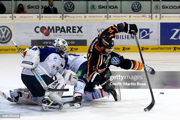 Norman Milley of Wolfsburg fails to score over Dennis Endras, goaltender of Mannheim in game four of the DEL semi final play-offs between Grizzly...