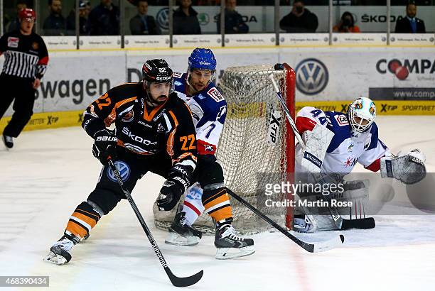 Matt Dzieduszycki of Wolfsburg and Sinan Akdag of Mannheim battle for the puck in game four of the DEL semi final play-offs between Grizzly Adams...