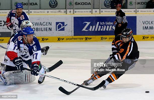 Marco Rosa of Wolfsburg and Nicolai Goc of Mannheim battle for the puck in game four of the DEL semi final play-offs between Grizzly Adams Wolfsburg...