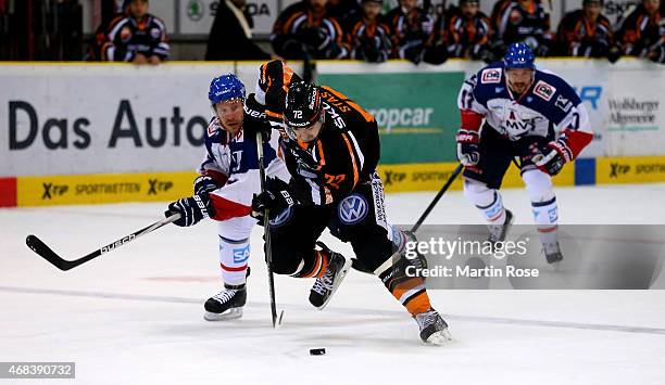 Sergej Stas of Wolfsburg and Nicolai Goc of Mannheim battle for the puck in game four of the DEL semi final play-offs between Grizzly Adams Wolfsburg...