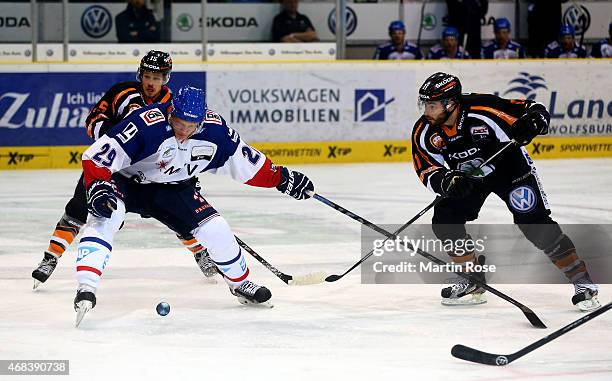 Brent Aubin of Wolfsburg and Denis Reul of Mannheim battle for the puck in game four of the DEL semi final play-offs between Grizzly Adams Wolfsburg...