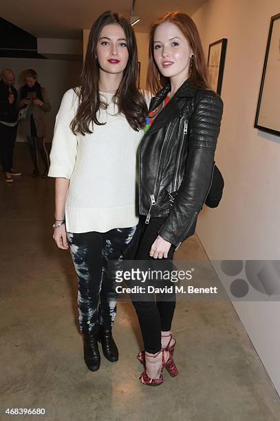 Millie Brady and Ellie Bamber attend a private view of "The Top Ten" by artist Hayden Kays at The Cob Gallery on April 2, 2015 in London, England.