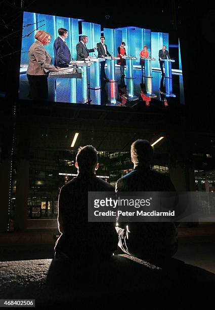 People watch a giant TV screen showing the leaders election debate at Media City on April 2, 2015 in Manchester, England. The televised leaders...