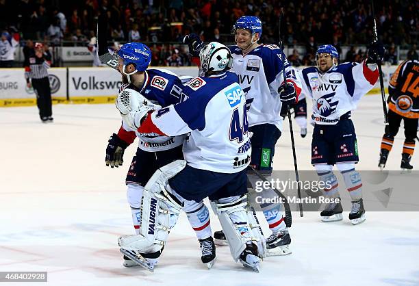 Andrew Joudrey of Mannheim celebrate with team mate Dennis Endras after he scores his team's game winning goal in game four of the DEL semi final...