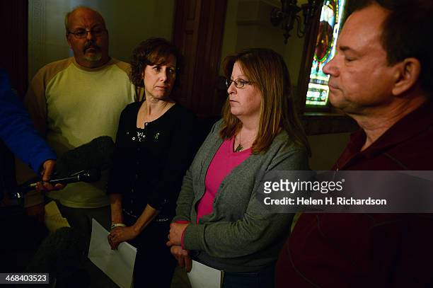 Theresa Hoover, second from right, mother of A.J. Boik who was killed at the Aurora theatre shooting, speaks to members of the media during a press...