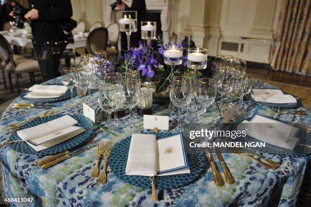 Place settings for the upcoming State Dinner in honor of French President Francois Hollande are displayed during a preview in the State Dining Room...