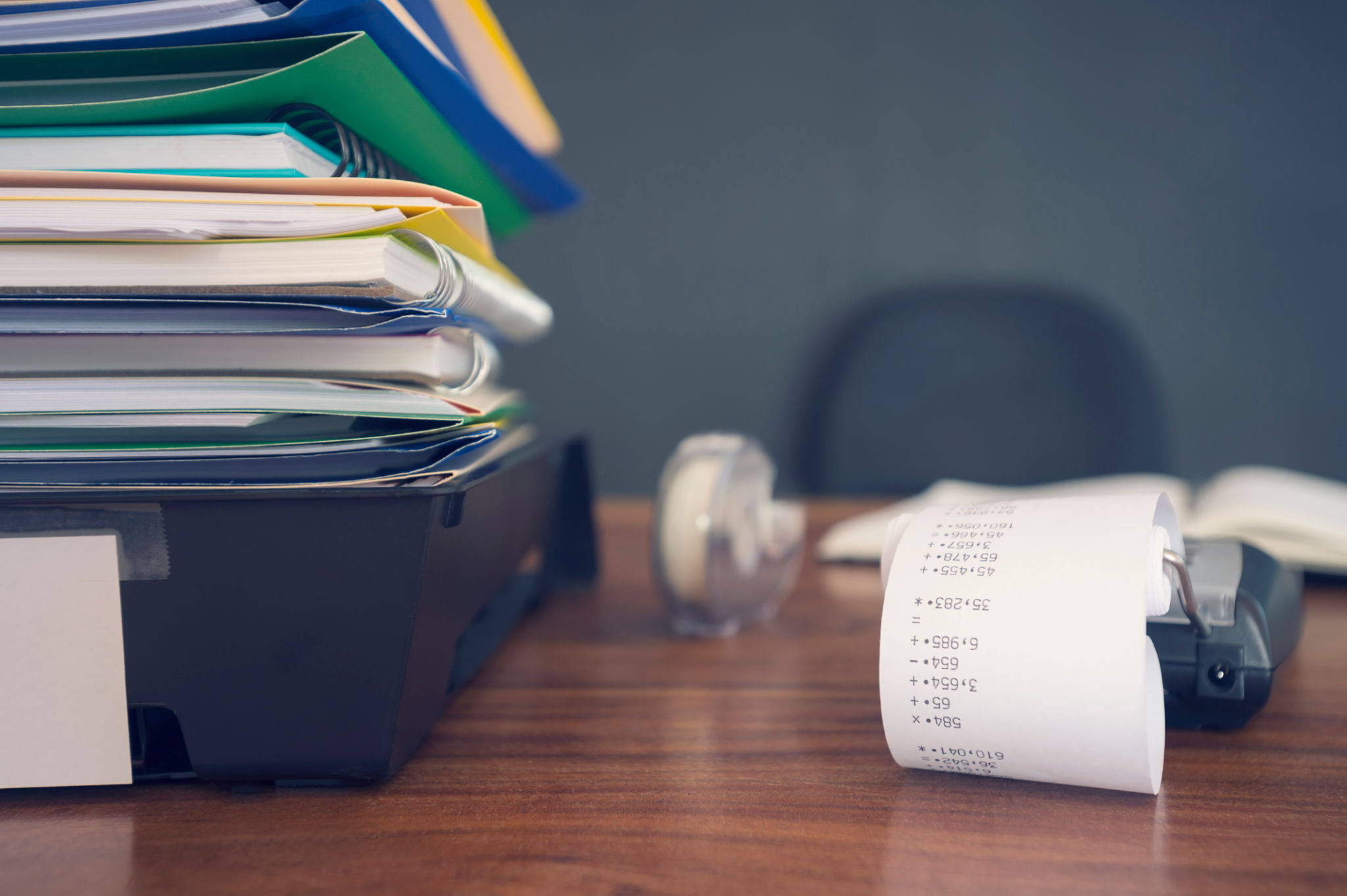 Large stack of paperwork and files with calculator. Large stack of paperwork and files with calculator.
