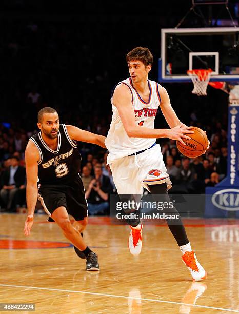 Alexey Shved of the New York Knicks in action against Tony Parker of the San Antonio Spurs at Madison Square Garden on March 17, 2015 in New York...