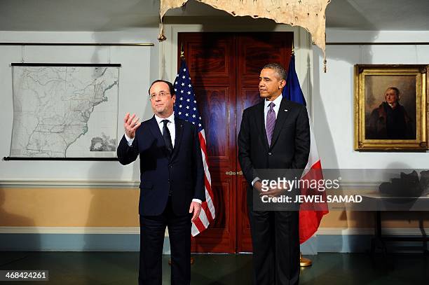 President Barack Obama listens as his French counterpart Francois Hollande makes a statement to the media following their tour of the Third US...