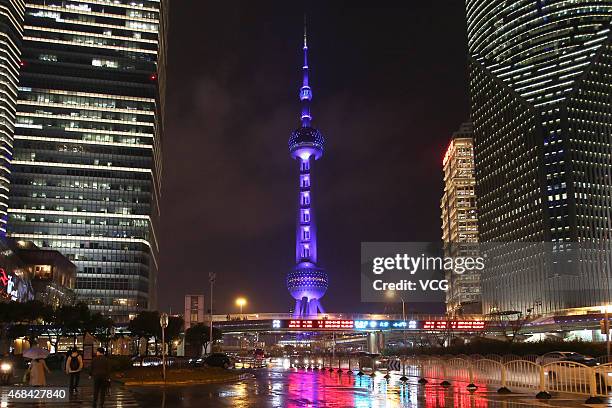 The Oriental Pearl Radio & TV Tower is lit in blue lights to promote scientific knowledge and show care to autistic children on April 2, 2015 in...