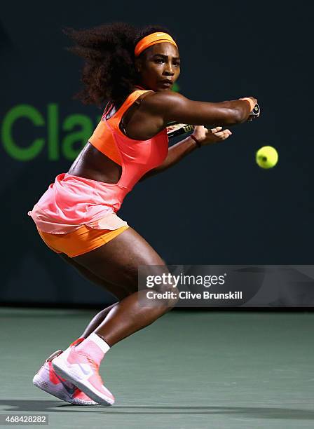 Serena Williams of the United States plays a backhand against Simona Halep of Romania in their semi final match during the Miami Open Presented by...