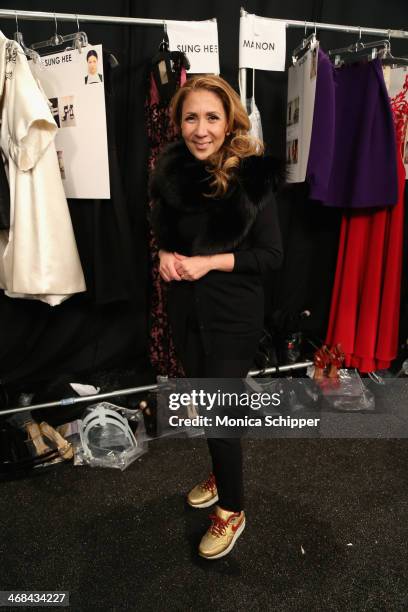 Designer Reem Acra prepares backstage at the Reem Acra fashion show during Mercedes-Benz Fashion Week Fall 2014 at The Salon at Lincoln Center on...