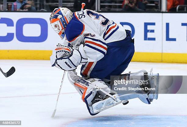 Goalie Ben Scrivens of the Edmonton Oilers hops as he makes a save against the Los Angeles Kings at Staples Center on April 2, 2015 in Los Angeles,...