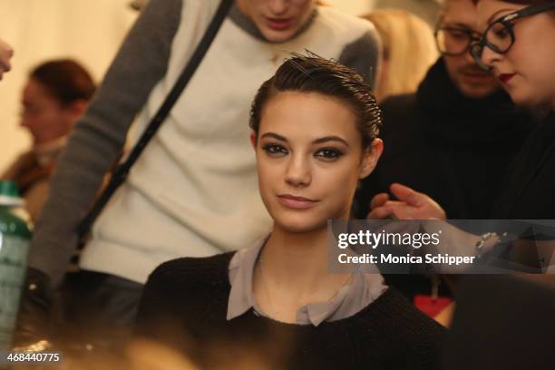 Model prepares backstage at the Reem Acra fashion show during Mercedes-Benz Fashion Week Fall 2014 at The Salon at Lincoln Center on February 10,...