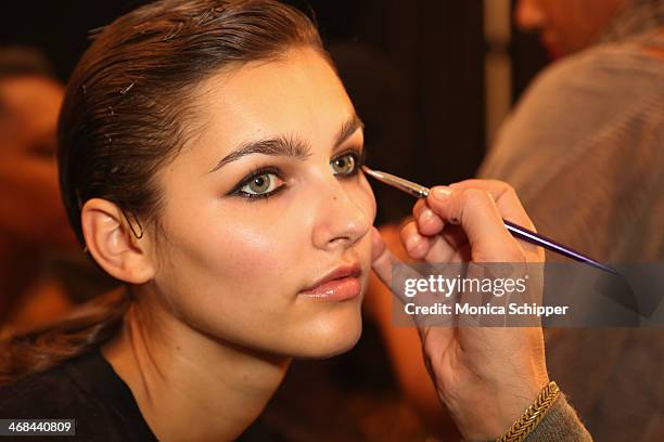 Model prepares backstage at the Reem Acra fashion show during Mercedes-Benz Fashion Week Fall 2014 at The Salon at Lincoln Center on February 10,...