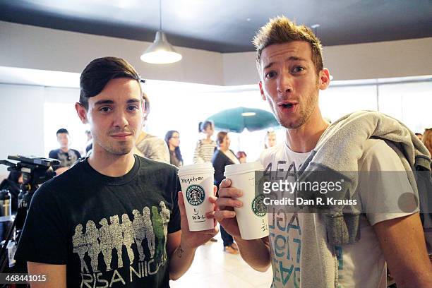 Customers Daniel Todd and Joshua Applegate pose with their free coffees at Dumb Starbucks in the Los Feliz neighborhood on February 10, 2014 in Los...