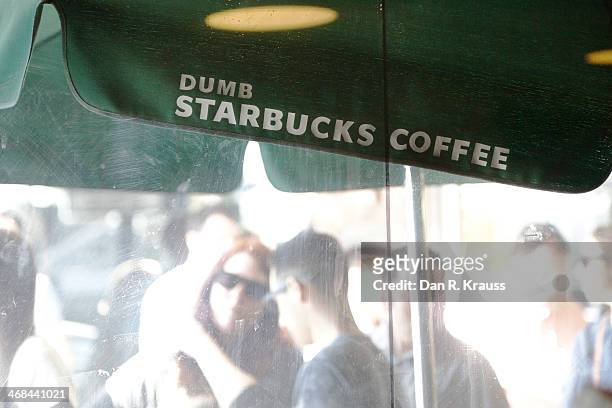 The line outside Dumb Starbucks stretches half way around the block with customers waiting roughly 2.5 hours for a free coffee in the Los Feliz...