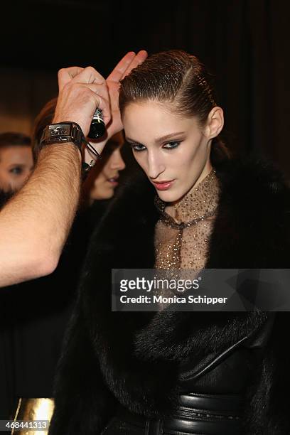 Model prepares backstage at the Reem Acra fashion show during Mercedes-Benz Fashion Week Fall 2014 at The Salon at Lincoln Center on February 10,...