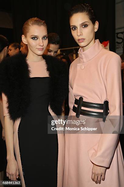 Models prepare backstage at the Reem Acra fashion show during Mercedes-Benz Fashion Week Fall 2014 at The Salon at Lincoln Center on February 10,...